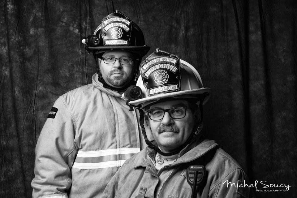 LeMoine fire chief Alfred Aucoin, and his son Jason Aucoin posing for a photo in their firefighter equipment.