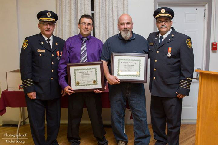 Photo of Cyril Chiasson, and Roger Bourgeois receiving a tribute for their live saving actions.