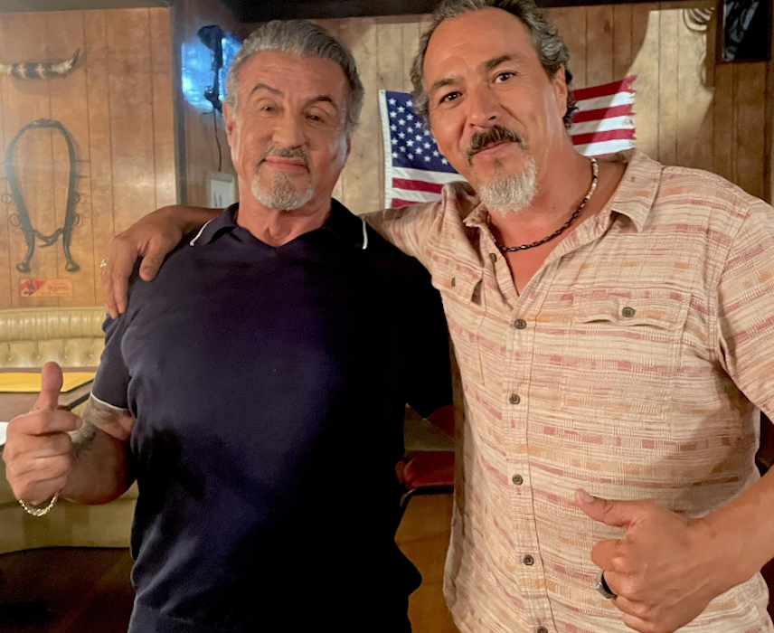 Glen and Stallone posing for a photo.