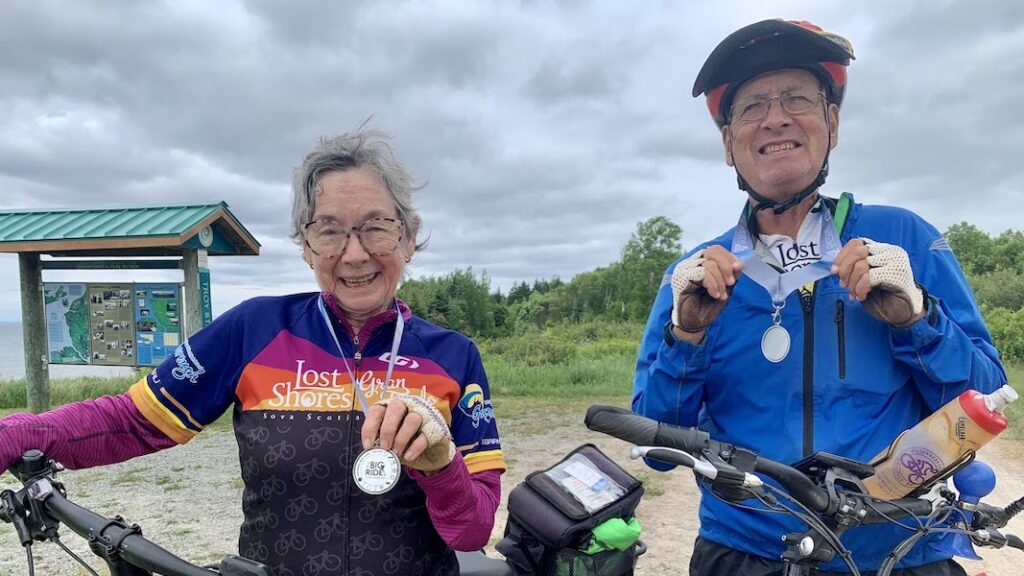 Alec MacNeil and Laura Cormier showing off their Big Ride medals.
