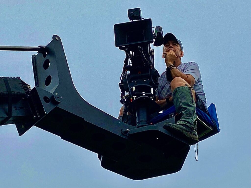 Photo of Patrick Doyle operating a boom camera.
